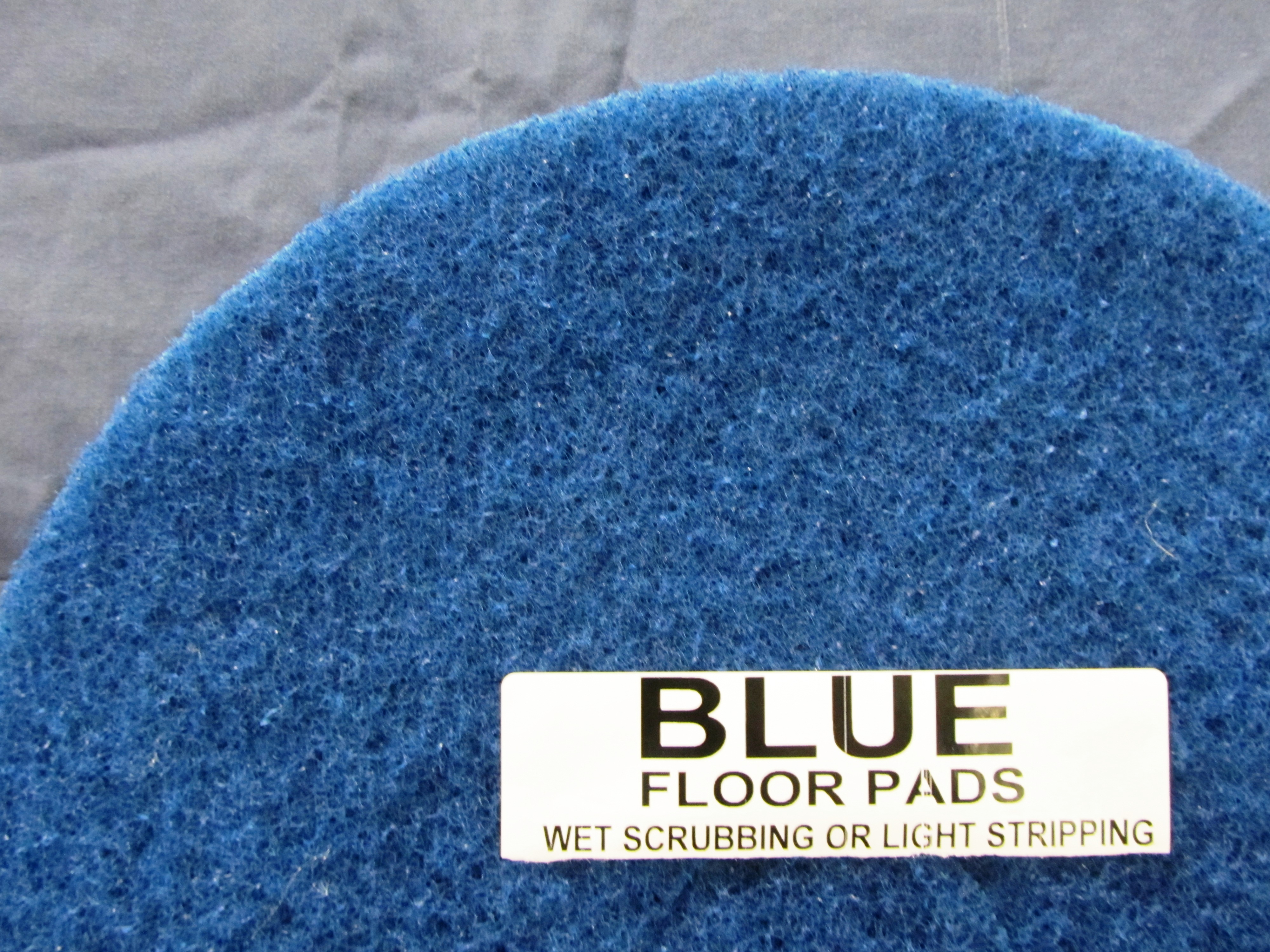 top half of blue floor pad, label displayed